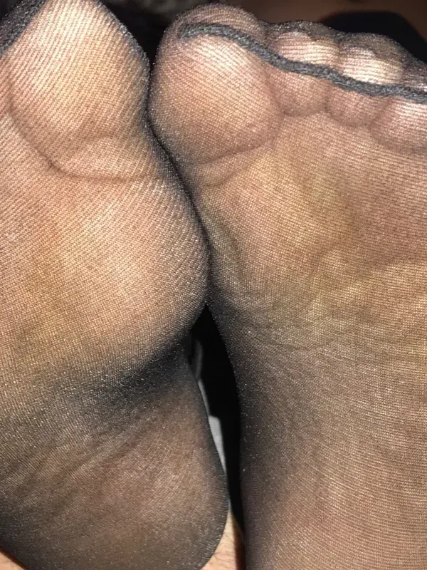 Pieds en bas noirs transparents, vue rapprochée, texture du tissu, lumière directe
